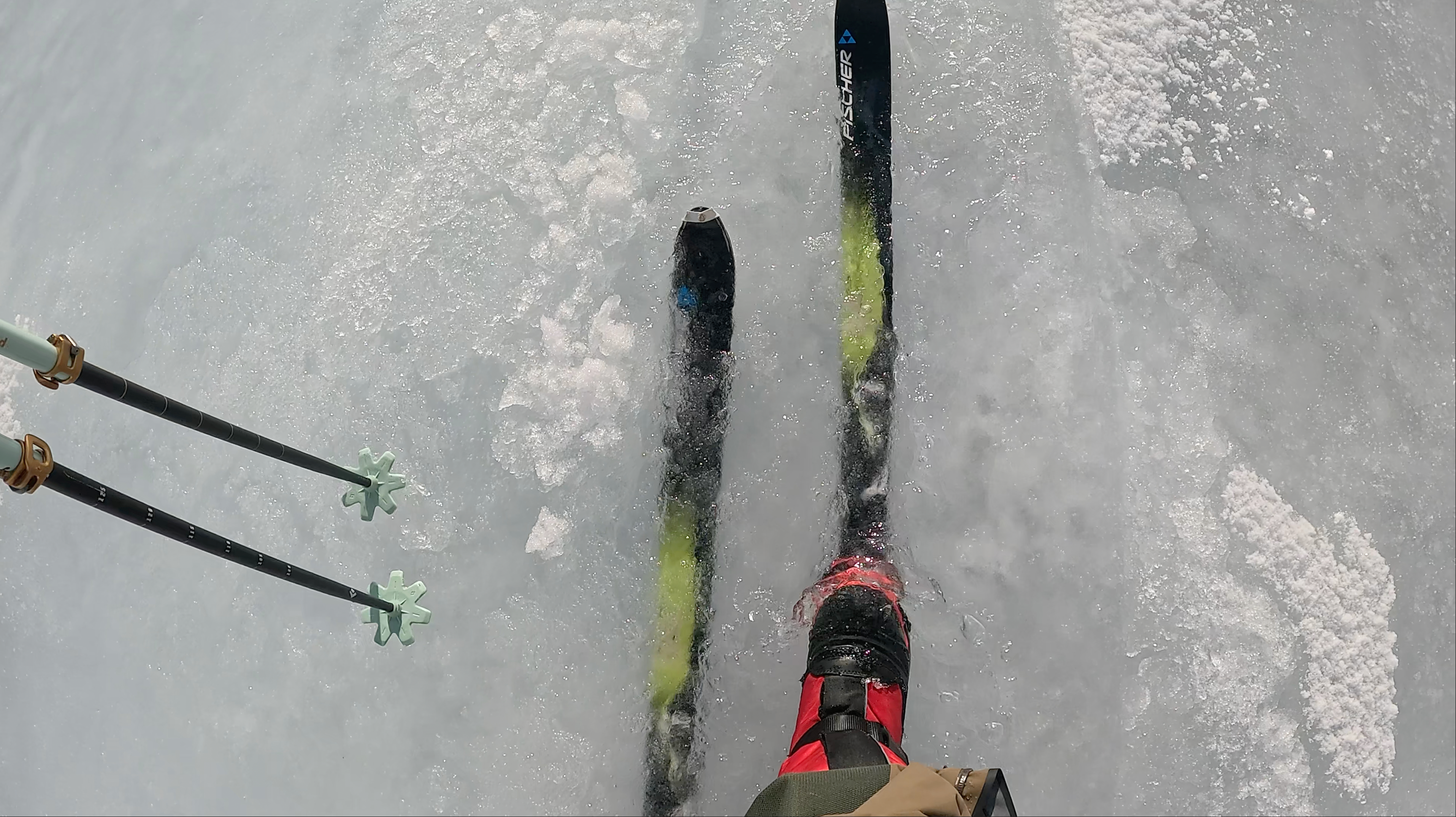 Skiing perspective with skis and poles on a snowy surface